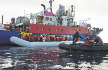  ?? Hermine Poschmann / Mission Lifeline ?? The ship Mission Lifeline, operated by a German aid group, rescues migrants Thursday from a rubber boat in the Mediterran­ean Sea off the Libyan coast. Italy has refused to let the ship dock in its ports.