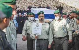  ?? (David Cohen/Flash90) ?? MOURNERS ATTEND the funeral of Border Police officer Yezen Falah, murdered in a terror attack in Hadera in March.