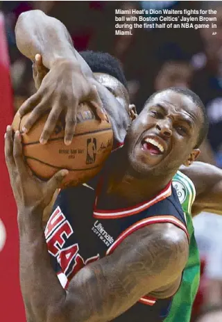  ?? AP ?? Miami Heat’s Dion Waiters fights for the ball with Boston Celtics’ Jaylen Brown during the first half of an NBA game in Miami.