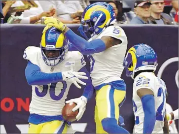  ?? Justin Rex Associated Press ?? ERNEST JONES, left, celebrates with his teammates after his first-half intercepti­on helped set up a touchdown. Jones started at linebacker for the first time after the team traded veteran Kenny Young last week.