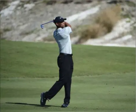  ?? DANTE CARRER — THE ASSOCIATED PRESS ?? Tiger Woods hits from the fairway at the third hole during the first round of the Hero World Challenge at the Albany Golf Club in Nassau, Bahamas, Thursday. Woods now is No. 13 in the world as he hosts this holiday tournament for the 20th time.