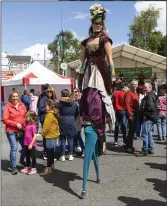  ??  ?? Walking on stilts.