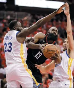  ?? AP PHOTO/DAVID J. PHILLIP ?? Houston Rockets guard James Harden, middle, shoots between Golden State Warriors forward Draymond Green, left, and guard Klay Thompson during the second half in Game 5 of the NBA’s Western Conference finals in Houston, Thursday.