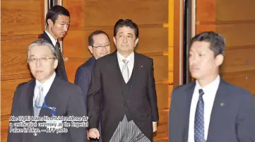  ?? — AFP photo ?? Abe (right) leaves his official residence for a certificat­ion ceremony at the Imperial Palace in Tokyo.