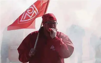  ?? AFP PIC ?? A union member taking part in a warning strike initiated by German trade union IG Metall at the Volkswagen plant in Zwickau, eastern Germany, in April last year. The union demanding shorter working week but with a limited loss of salary under certain...