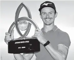  ??  ?? Daan Huizing proudly displays the trophy after winning the Jordan Mixed Open.