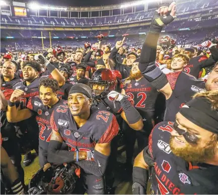  ?? HAYNE PALMOUR IV ?? Will the Aztecs players celebrate on the field with no fans in the stands, as they did here after beating BYU last season at home?