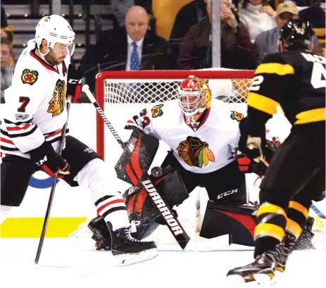  ??  ?? Blackhawks defenseman Brent Seabrook blocks a shot in front of goalie Scott Darling during the third period Friday.