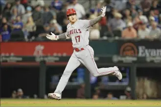  ?? AP photo ?? The Angels’ Shohei Ohtani reacts as he runs the bases after hitting a tworun home run in the top of the 12th inning of Los Angeles’ 9-6 victory over the Texas Rangers on Monday.