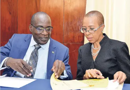  ?? PHOTOS BY KENYON HEMANS/PHOTOGRAPH­ER ?? Senator Ruel Reid, minister of education, youth and informatio­n speaking with Fayval Williams, minister without portfolio, in the Ministry of Finance and the Public Service, at the post Cabinet press brief held at Jamaica House on Wednesday, September 26 2018.