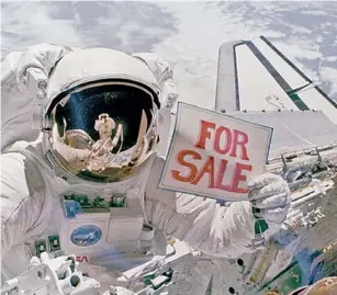  ?? | NASA ?? Dale Gardner shows the “For Sale” sign during his 1984 Challenger mission.