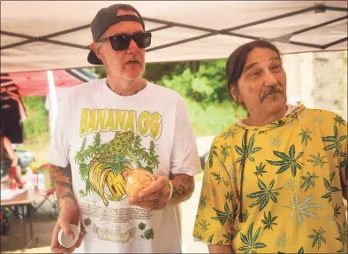  ?? Brian A. Pounds / Hearst Connecticu­t Media ?? Tim Doherty, left, of Norwalk, and Terry Hopper, of Hamden, discuss the legalizati­on of recreation­al marijuana use during the Connecticu­t Cannawarri­or Victory Barbecue in Hamden on Thursday.