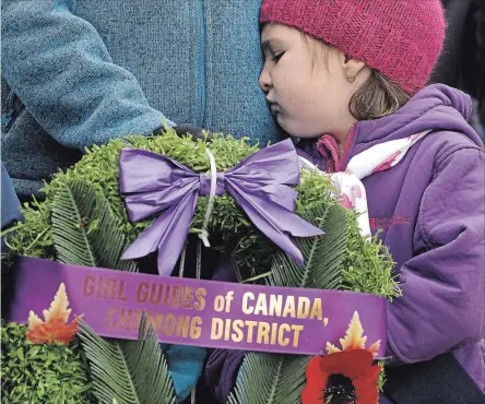  ?? CLIFFORD SKARSTEDT EXAMINER ?? 1st Ennismore Sparks Lilly Smith, 5, reacts to the Last Post before laying a wreath during the Remembranc­e Service in Bridgenort­h on Wednesday.