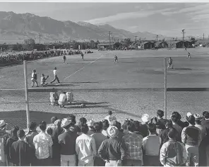  ?? PHOTOS PROVIDED BY ANSEL ADAMS VIA LIBRARY OF CONGRESS ?? Ansel Adams captured an amateur baseball game at the Japanese- American mass incarcerat­ion camp.