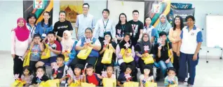  ??  ?? Above: Lee (standing, sixth left) with 7-Eleven Malaysia and ngohub.asia volunteers, with MFD interprete­rs and the ‘hard-of-hearing’ children at the Merdeka-themed activity-based event. Below: The children and volunteers busy with their Merdeka-themed...