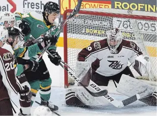  ?? CLIFFORD SKARSTEDT EXAMINER ?? Peterborou­gh Petes goalie Hunter Jones, seen blocking a shot deflected by London Knights’ Jonathan Gruden on Thursday at the Memorial Centre, could be out of the Petes lineup for several weeks if he makes Team Canada’s final lineup for the world junior championsh­ip.