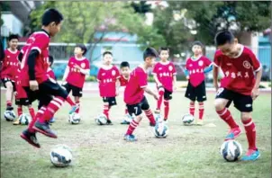  ?? JOHANNES EISELE/AFP ?? Children attend a football training session in the suburbs of Guangzhou in southern China’s Guangdong province on January 12.