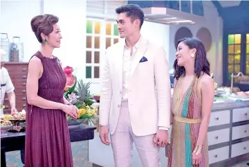  ??  ?? (From left) Tan Sri Michelle Yeoh, Henry Golding and Constance Wu star in ‘Crazy Rich Asians.’ — Photo by Sanja Bucko, Warner Bros. Pictures