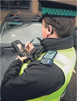  ?? Picture: Steve MacDougall. ?? A Perth and Kinross Council parking attendant in Blackfriar­s Wynd, Perth.