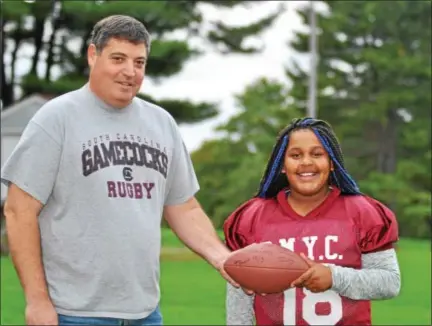  ?? BARRY TAGLIEBER — FOR DIGITAL FIRST MEDIA ?? Phoenixvil­le Marian Youth Club’s Peyton Donahue, right, smiles with head coach Brian Watson. Donahue recently became the first girl to score a touchdown in the 62-year history of the PMYC.