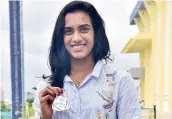  ??  ?? Sindhu poses with the medal. — DECCAN CHRONICLE