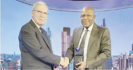  ?? PHOTO BY BOI ?? L-R: Editor-in-chief, Finance Publishing, Simon Brown, presenting, ’Best Developmen­t Bank Africa 2022 “to managing director/CEO, Bank of Industry (BOI) Olukayode Pitan at the Internatio­nal Banker 2022 Banking Award held at London Stock Exchange yesterday.