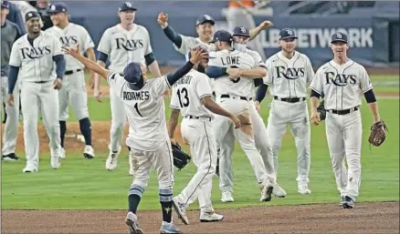  ?? Jae C. Hong Associated Press ?? TAMPA BAY players exult after beating Houston in Game 7 of the ALCS. At 40- 20, the Rays had the AL’s best record this season.