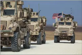  ?? BADERKHAN AHMAD — THE ASSOCIATED PRESS ?? An American military convoy stops near the town of Tel Tamr, north Syria, on Sunday. Kurdish-led fighters and Turkish-backed forces clashed sporadical­ly over the weekend.