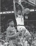  ?? GEOFF BURKE/USA TODAY SPORTS ?? The Knicks’ Obi Toppin dunks as the Wizards’ Rui Hachimura looks on during Friday’s game in Washington.