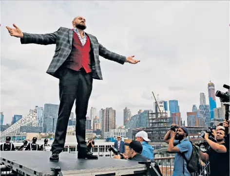  ??  ?? Road to recovery: Tyson Fury in London promoting the forthcomin­g fight with Deontay Wilder, above, and gym work with trainer Ben Davison, left. Fury with his wife, Paris, far left