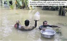  ??  ?? A police officer, left, and a volunteer carry essential supplies in Chengannur, Kerala