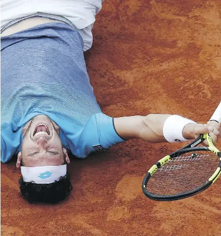  ?? THE ASSOCIATED PRESS ?? Italy’s Marco Cecchinato collapses on the clay after upsetting Serbian Novak Djokovic in their quarterfin­al match on Tuesday at the French Open. The 72nd-ranked Italian won 6-3, 7-6 (4), 1-6, 7-6 (11).