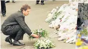  ?? ?? SOMBRE Blair in 1996. Right, flowers left at scene of 2021 Plymouth attack, in which five people were shot dead