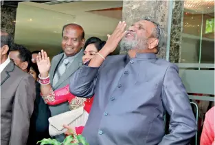  ??  ?? Election Commission Chairman Mahinda Deshapriya blows a flying kiss to his daughter and son-in-law at their wedding on Thursday. Pic by Indika Handuwala