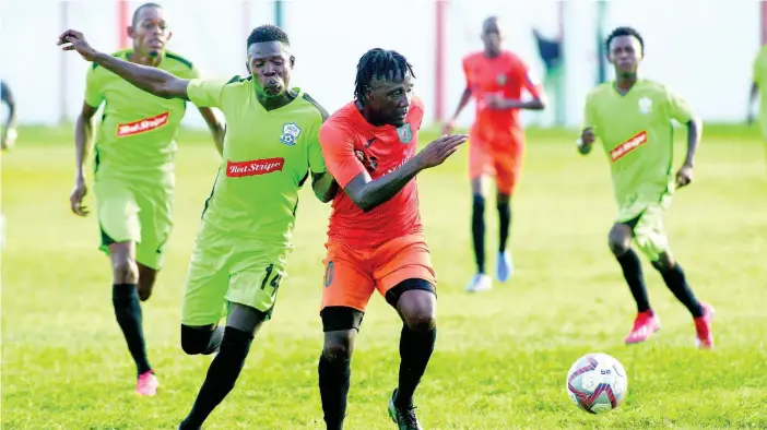  ??  ?? Tivoli Gardens’ Jermaine Johnson evades the challenge of Molynes FC defender, Sergeni Frankson in the teams’ RSPL encounter at the Edward Seaga Sports Complex on December 11.