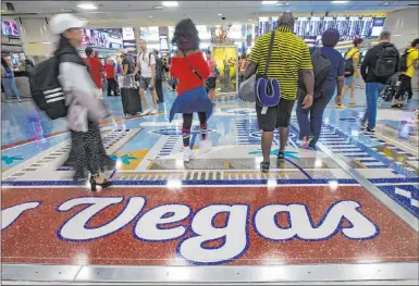  ?? Chase Stevens Las Vegas Review-journal @csstevensp­hoto ?? Passengers walk in August 2019 around the baggage claim area at Mccarran Internatio­nal Airport. In a new survey, 61.1 percent of people said they are uncomforta­ble traveling on a commercial airliner amid the coronaviru­s outbreak.