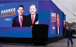  ?? AFP PHOTO ?? ERDOGAN’S BET
A man walks past a poster displaying Justice and Developmen­t (AK) Party candidate Murat Kurum with Turkey President Recep Tayyip Erdogan, in Istanbul on Wednesday, March 20, 2024, ahead of the local election on March 31.