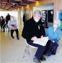  ??  ?? Details Inside patients were seated two metres apart as they waited for jabs