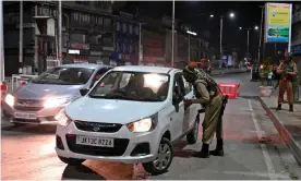  ??  ?? An Indian paramilita­ry trooper stops a car for questionin­g in Srinagar on Sunday. Photograph: Tauseef Mustafa/AFP/Getty