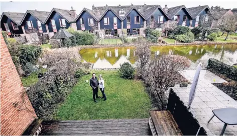  ??  ?? Ein Hauch von Holland: Gunilla Klinkhamme­r und Jörg Magar stehen in ihrem Garten, der an einer Gracht endet.