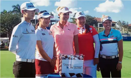  ??  ?? Star players: (From left): Park Sung-hyun, Ryu So-yeon, Lexi Thompson, Feng Shanshan and Brooke Henderson posing on Tuesday before a glass case, reflecting the US$1mil cash bonus up for grabs this week at the CME Group Tour Championsh­ip in Naples,...