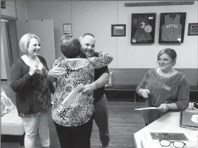  ?? Courtesy Photo/KARYN TECLE ?? Stephen Bowman, Garfield Elementary School principal, hugs Laura Wilson, a Rogers Public Education Foundation board member, upon receiving a $1,000 check for the school from the foundation on May 8. Foundation board member Rachel Harris (left) and...