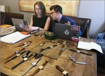  ?? AMIR BIBAWY — THE ASSOCIATED PRESS ?? In this photo watches lie on a table in front of Christian Zeron as he talks with Anna Griffin in Westfield, N.J. Zeron’s company website, theoandhar­ris.com, sells $2 million’s worth of watches annually. Regularly Zeron gets hundreds of thousands of views for his four weekly video posts on YouTube.