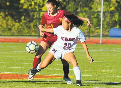  ?? Christian Abraham / Hearst Connecticu­t Media ?? Brien McMahon’s Viviana Luna, right, tries to hold off St. Joseph’s Helen Mahoney during their FCIAC quarterfin­al Thursday in Trumbull. No. 2 St. Joseph defeated No. 7 McMahon 2-0.