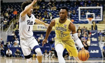  ?? JARED WICKERHAM / ASSOCIATED PRESS ?? Georgia Tech guard Josh Okogie drives to the basket past Panthers guard Parker Stewart on the Yellow Jackets’ way to a 69-54 ACC victory Saturday in Pittsburgh.