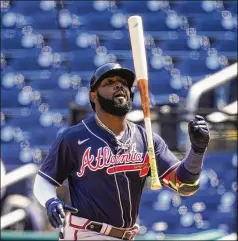  ?? ALEX BRANDON/ASSOCIATED PRESS ?? The Braves’ Marcell Ozuna reacts after striking out against the Washington Nationals last week. Ozuna, who flirted with the Triple Crown last season, has slumped: 4-for-32 with 13 strikeouts and no extra-base hits through nine games this season.