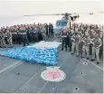  ?? ?? HMS Lancaster and the Marines pose with the 3.7 tonnes of trafficked drugs