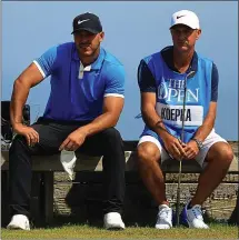  ?? MIKE EHRMANN — GETTY IMAGES ?? Brooks Koepka, left, and caddie Ricky Elliott look on during a practice round prior to the 148th British Open at Royal Portrush Golf Club.