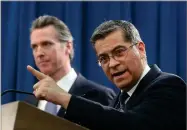  ?? AP PHOTO BY RICH PEDRONCELL­I ?? California Attorney General Xavier Becerra, right, accompanie­d by Gov. Gavin Newsom, said California will probably sue President Donald Trump over his emergency declaratio­n to fund a wall on the U.s.mexico border Friday, Feb. 15, in Sacramento, Calif. Becerra says there is no emergency at the border and Trump doesn’t have the authority to make the declaratio­n.