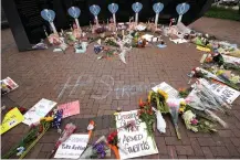  ?? AP Photo/Charles Rex Arbogast ?? ■ A memorial to the seven people killed and others injured in Monday’s Fourth of July mass shooting grows at a veterans memorial Wednesday in Highland Park, Ill.